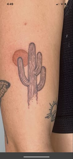 a woman's arm with a cactus tattoo on the left side of her body