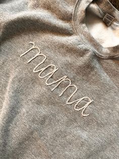 Hand embroidered Mama sweatshirt. Please inform me of what color lettering and what color sweatshirt you would like. Embroidered Grandma Sweatshirt, Winter Crew Sweatshirt With Letter Embroidery, Gray Letter Embroidery Sweatshirt For Fall, Fleece Sweater With Letter Embroidery For Fall, Fleece Crew Neck Sweater With Letter Embroidery, Fleece Sweatshirt With Letter Embroidery For Fall, Fall Embroidered Text Fleece Sweater, Winter Sweatshirt With Letter Embroidery And Crew Neck, Fall Fleece Sweater With Embroidered Text