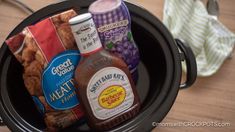 an open crock pot filled with condiments and food