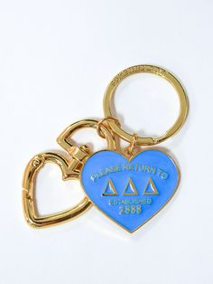 a blue heart shaped keychain with the words please return to law on it