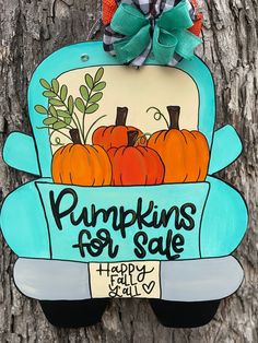 a sign that says pumpkins for sale hanging on a tree with the words happy fall y'all over it