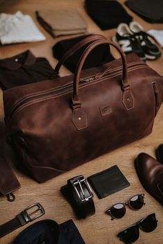 The Weekender Travel Leather Duffle Bag is the travel bag that will travel with you through the ages. A travel bag that is both rugged and delicate, Weekender is the bag that will bring you a journey that is profound because of its expansive design. Hand-polished Zippers make it easy to slip through and have easy access. The voluminous space allows you to carry all of your travel items in style like never before. The lining is made of 100% pure cotton and allows you to place all of your items Brown Travel Accessories With Leather Handles, Everyday Brown Travel Accessories With Leather Handles, Cognac Travel Bag With Luggage Sleeve, Cognac Duffle Bag With Luggage Sleeve For Overnight Trips, Brown Satchel For Everyday Use, Brown Satchel For Everyday Travel, Classic Brown Duffle Bag For Trip, Brown Luggage With Sleeve For Trips, Classic Brown Shoulder Bag For Overnight Trips