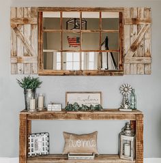 a wooden table with two mirrors above it