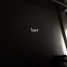 the word her written in white on a black wall