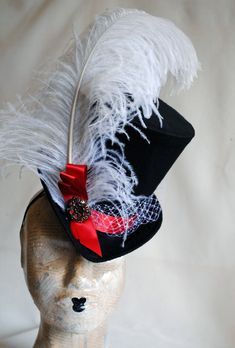 This elegant victorian riding ladies top hat is covered with fine black silk shantung. It is adorned with a lush white ostrich feather, white birdcage veil around the crown and red satin ribbon in a half bow along with dark silver decorative element. Also available in Total Black or Total White! Just click on the drop menu to pick which version you prefer! The Black/White/Red Version is READY TO SHIP out within a couple of days! Other color options are MADE TO ORDER! Fully lined with satin. Atta Elegant Fitted Top Hat For Halloween, Elegant Top Hat For Kentucky Derby Costume Party, Gothic Fitted Brimmed Top Hat, Elegant Costume Top Hat With Short Brim, Black Top Hat For Costume, Gothic Fitted Top Hat With High Crown, Gothic Top Hat With High Crown, Fitted Gothic Brimmed Top Hat, Elegant Top Hat With Short Brim For Costume