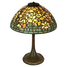 a stained glass lamp sitting on top of a table