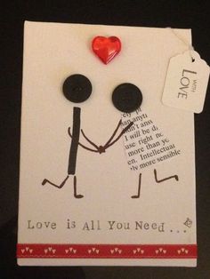 a greeting card with two stick figures holding hands and a red heart attached to it