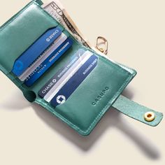 a wallet with two credit cards and a keychain attached to the card holder