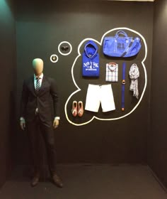 a mannequin is standing in front of a wall with clothing and accessories on it