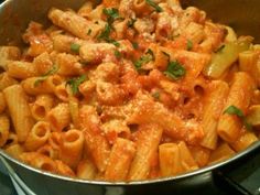 a pan filled with pasta and meat covered in sauce