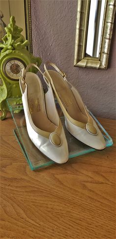 This is a pair of vintage 80's cream and beige leather sling back pumps. Made in Italy. Maker: Salvatore Ferragamo Condition: Very good with minimal wear and scuffs Heel: 2 3/4 inches Size: 6 1/2 AA Vintage White Ankle Strap Heels, Vintage White Heels With Ankle Strap, Vintage Pointed Toe Slingback Pumps For Summer, Vintage Slingback Pumps For Spring, Vintage Slingback Pumps For Spring Formal, Vintage Beige Pointed Toe Heels, Vintage Cream Heels For Summer, Vintage Beige High Heel Heels, Cream Slingback Pumps With Round Toe For Evening