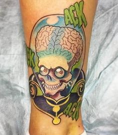 a person with a skull and brain tattoo on their leg