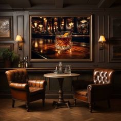 two leather chairs and a table in a room with pictures on the wall behind them