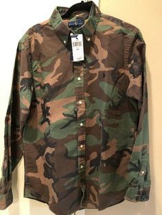 THIS IS A NEW WITH TAGS RALPH LAUREN POLO BUTTON FRONT OXFORD SHIRT. IT IS SIZE MEDIUM  / M. IT IS A CLASSIC FIT SHIRT. IT IS 100%  COTTON  AND IT IS A BROWN ANFD GREEN CAMO / CAMOUFLAGE . THE RALPH LAUREN POLO HORSE AND RIDER IS ON THE LEFT CHEST.  THE SHIRT HAS LONG SLEEVES, A BUTTON DOWN  COLLAR AND BUTTONS DOWN THE FRONT.  IT IS WASHABLE.  The chest measures 22" from underarm seam to underarm seam and the length is 31". The tag is still on it.  I guarantee this to be an authentic Ralph Laure Ralph Laure, Polo Horse, Military Outfit, Button Down Collar, Oxford Shirt, Green Camo, Streetwear Outfit, Casual Button Down Shirts, Button Downs