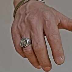 a man's hand with a ring on it