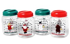 three glass jars with santa claus and snowmen on the lids, one has a red lid