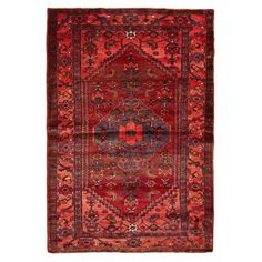 an antique persian rug with red and blue colors