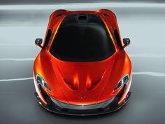 an orange sports car is shown from above