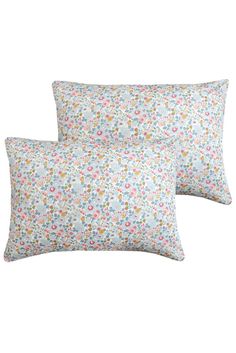 two pillows with flowers on them, one is blue and the other has pink and yellow