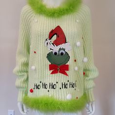 Personalized Holiday Party Outfit featuring the Grinch.  This Ugly Christmas Sweater is a size large in pastel green.   Quality in mind, my holiday patterns are custom made and unique to each sweater.   A velvet soft  grinch face takes center stage. Faux Fur Boa is trimmed at neckline and hem. I use vintage or repurposed sweaters.  This  sweater is from the brand Wild Fable.  The soft knit Acrylic makes the sweater comfortable and cozy. It is a loose fit.  I hope you are as excited as me to stan Repurposed Sweaters, Der Grinch, Le Grinch, Grinch Face, Holiday Patterns, Holiday Party Outfit, Pastel Green, Wild Fable, Center Stage