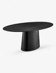 an oval wooden table with black wood grain on the top and base, in front of a white background