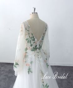 a white dress with flowers and leaves on it