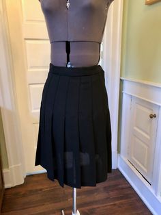 This easy care classic is great for petites with its' shorter length. This skirt is made of 100% polyester black crepe fabric. It is unlined. It features a waistband with side zipper and button closure, and permanent pleats. This garment is clean, with no stains or snags. Measurements to guide you: Waist: 26-27" Hip: 44" Length: 21" Decade: Fabric: Polyester Crepe Size: S Condition: Great Brand: Wheaton & Katz Ltd. It's a delight to pick through time for you to find these vintage treasures. Pleated Short Skirt For Work, Fitted Pleated Skirt With Accordion Pleats For Workwear, Classic Fitted A-line Bottoms, Accordion Pleated Skort For Workwear, Accordion Pleated Skort For Work, Accordion Pleats Skort For Workwear, Workwear Fitted Pleated Mini Skirt, Formal Fitted Mini Skirt With Accordion Pleats, Elegant Short Skirt With Accordion Pleats