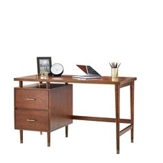 a wooden desk with two drawers and a clock