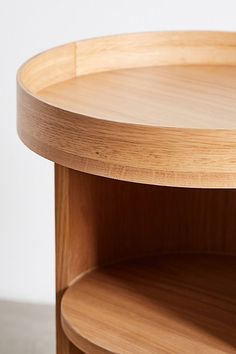 a close up of a wooden table with a white wall in the background