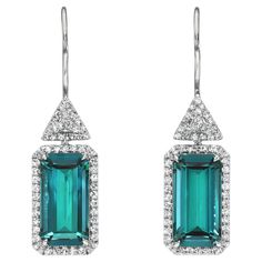 Rare 9.87 Carat Indicolite Tourmaline Platinum Earrings with Signature Diamond Studs by Merkaba Jewelry Beverly Hills. Discover unmatched luxury and timeless sophistication with these 9.87 carat Indicolite Tourmaline earrings, crafted in the finest platinum. Showcasing exceptional emerald-cut tourmalines in a rare and vivid shade of blue-green, these earrings radiate elegance and exclusivity. Each tourmaline is framed with a total of 0.64 carats of collection-grade round single-cut diamonds, del Emerald Bracelets, Triangle Diamond, Pave Jewelry, Earrings Emerald, Platinum Earrings, Indicolite Tourmaline, Tourmaline Earrings, Romantic Gestures, Rare Gemstones