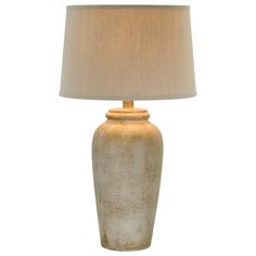 a table lamp with a beige shade on it