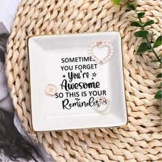 a white plate sitting on top of a table next to a plant and some pictures