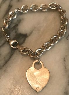 "This is a beautiful and heavy solid link bracelet with heart charm.  It is sterling silver with a lobster claw clasp.  Both the bracelet and charm are marked with makers mark and 925.  The bracelet is approximately 7 3/8\" with 1 1/8\" heart charm.  A wonderful classic gift for that special someone! Thank you for visiting Vintage Great Gets 💕" Akoya Pearl Necklace, Bracelet With Heart, Wide Cuff Bracelets, Silver Pearl Necklace, Pearl Pendant Necklace, Hinged Bangle, Photo Bracelet, Bracelets And Charms, Tiffany Heart