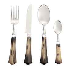 three forks, two spoons and one knife on a white background with black spots