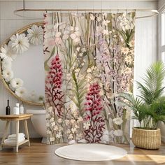 the shower curtain is decorated with flowers and plants in front of a large round mirror