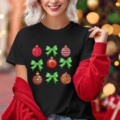 Get into the holiday spirit with our Christmas Croquette and Ornament T-Shirt! This festive tee is the perfect blend of holiday cheer and mom life, designed for all the amazing mamas out there who make Christmas magical. Whether you're decorating the tree, baking cookies, or shopping for gifts, this shirt is a must-have for your holiday wardrobe. 🌟 Features: Premium Comfort: Made from soft, high-quality cotton for a cozy and breathable feel. Perfect for all-day wear during holiday festivities. Black Top As Christmas Gift, Festive Christmas Crew Neck T-shirt, Christmas Holiday Crew Neck Shirt, Black Christmas Festive Tops, Christmas Holiday Graphic T-shirt, Festive Black Christmas Tops, Black Festive Christmas Top, Black Christmas Holiday Top, Festive Black Christmas Top