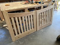 a workbench made out of wood with tools on the table and other items around it