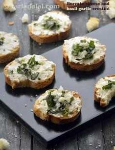 several pieces of bread topped with cheese and herbs