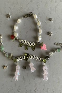 two bracelets with beads and charms attached to them