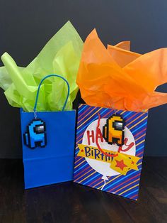 two bags that have been made to look like pacman and happy birthday paper bags