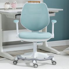 a blue office chair sitting on top of a white desk next to a computer monitor