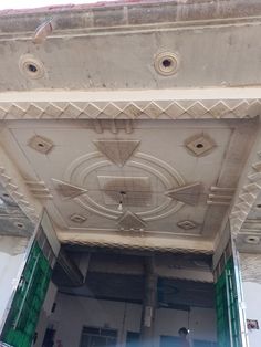 an open doorway with decorative plaster work on the ceiling