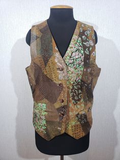 Stylish colorful women's leather vest. Comfortable women's leather vest with plastic buttons. The vest is made of different pieces of durable soft brown leather. Some pieces are decorated with a silver pattern. The vest is easily fastened with plastic buttons and tied with a leather strap from the back. The vest has two front pockets. The vest has a nice polyester lining. The vest is light and pleasant to wear, has a wonderful unique look, will be comfortable for you and perfectly emphasizes your unique image. MEASUREMENTS Length  vest                    61 cm  | 24 in  Pit to pit                          54 cm  |  21.5 in Chest  circumference    108 cm  |  42.5 in  Waist  circumference    104 cm  |  41 in Bottom circumference  100 cm  |  39.5 in Measurements are taken in cm with garment l Fitted Sleeveless Patchwork Vest, Fitted Patchwork Vest For Spring, Multicolor Patchwork Vest, Fitted Sleeveless Outerwear For Festival, Fitted Patchwork Vest For Fall, Fitted Vest With Buttons For Festival, Fitted Multicolor Vest For Winter, Multicolor Fitted Winter Vest, Sleeveless Brown Vest For Festivals