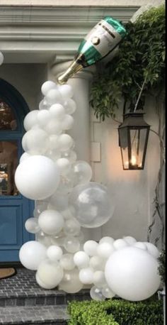 a bunch of balloons that are in front of a house