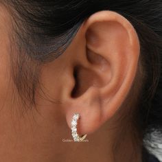 Colorless Round Cut Moissanite Huggies Earring In 14K Solid Gold. Crafted To Perfection, These Earrings Are The Ideal Wedding Gift For Her. With Their Timeless Design And Stunning Colorless Round-Cut Moissanite Stones, They Will Add An legant touch to any outfit.  𝐒𝐊𝐔: - GBJ1059 ✥ 𝐌𝐚𝐢𝐧 𝐒𝐭𝐨𝐧𝐞 𝐃𝐞𝐭𝐚𝐢𝐥𝐬 ↣ Shape: Round Cut ↣ Type: Moissanite ↣ Weight: 1.00 CTW (App.)  ↣ Color/Clarity: Colorless/VVS ↣ Making Process: Handmade - Crafted by our experienced team ✥ 𝐄𝐚𝐫𝐫𝐢𝐧𝐠𝐬 𝐃𝐞𝐭𝐚𝐢𝐥𝐬 ↣ Metal Purity: Solid Gold (10KT, 14KT, 18KT); Silver (925 Sterling, 935 Argentium), 950 Platinum ↣ Metal Tone: Yellow, White, Rose ↣ Stamp: Yes ✥ 𝐅𝐨𝐥𝐥𝐨𝐰 𝐔𝐬 Instagram:  @goldenbirdjewels  Facebook: @goldenbirdjewels Pinterest: @goldenbirdjewels Wedding White Cubic Zirconia Huggie Earrings, White Cubic Zirconia Huggie Earrings For Wedding, Single Cubic Zirconia Bridal Earring For Anniversary, White Round Cut Huggie Earrings For Wedding, Cubic Zirconia Huggie Earrings For Anniversary, Sterling Silver Huggie Earrings For Wedding, Gift Diamond White Hoop Earrings With Prong Setting, Wedding Hoop Earrings With Diamond Accents In Diamond White, Diamond White Hoop Earrings With Prong Setting As Gift