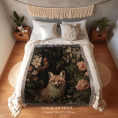 a bed covered in a blanket with a fox on it's head and flowers