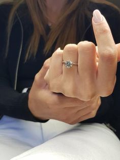 a woman is holding her hand up to the camera