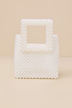 The Brilliant Vision White Pearl Mini Handbag will be the perfect addition to any bachelorette party look! This luxe purse is composed of gleaming faux pearls that create a structured, yet flexible see-through silhouette with a flat bottom design and square tote-style handles. An open top reveals a roomy interior with plenty of space for all of your must-have essentials. Unlined. Bag Measures 6" Wide 8" Tall And 2" Deep. Handles Have A 3" Drop. 100% Plastic. Imported. Lulus | Brilliant Vision Wh Handmade Clutch, Bottom Design, Pearl Heart, Mini Handbag, Heart Bag, Party Look, Mini Handbags, Party Looks, Open Top