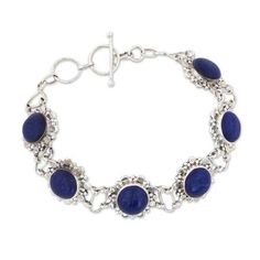 India's Shanker works with local artisans to help them create beautiful pieces of jewelry. He presents this link bracelet which features a handcrafted design from sterling silver to showcase round stones of lapis lazuli that capture the glamour of night. Bohemian Sterling Silver Oval Bracelets, Bohemian Oval Sterling Silver Bracelets, Sterling Silver Bracelets With Natural Stones, Adjustable Oval Sterling Silver Bracelet Nickel Free, Artisan Sterling Silver Jewelry With Jubilee Bracelet, Adjustable Round Sterling Silver Bracelet, Spiritual Sterling Silver Bracelet With Natural Stones, Blue Sterling Silver Bracelet, Stamped 925 Round Lapis Lazuli Jewelry