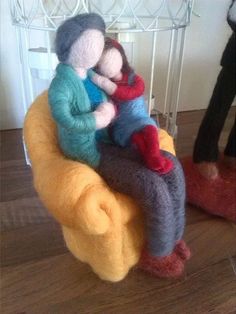 two stuffed animals sitting on top of a yellow chair